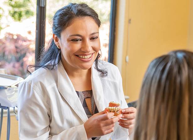 Photo of a female staff member laughing with a male patient.